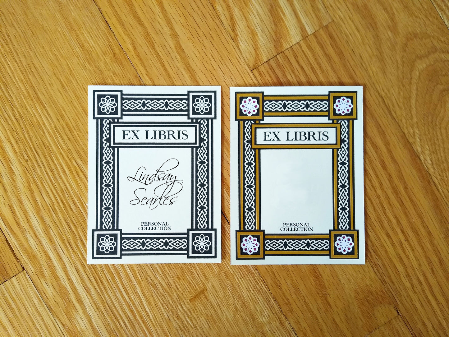 One black and white bookplate and one gold embellished bookplate are side by side.  The bookplates say Ex Libris and Personal Collection, and have a thick art deco border around the edges.